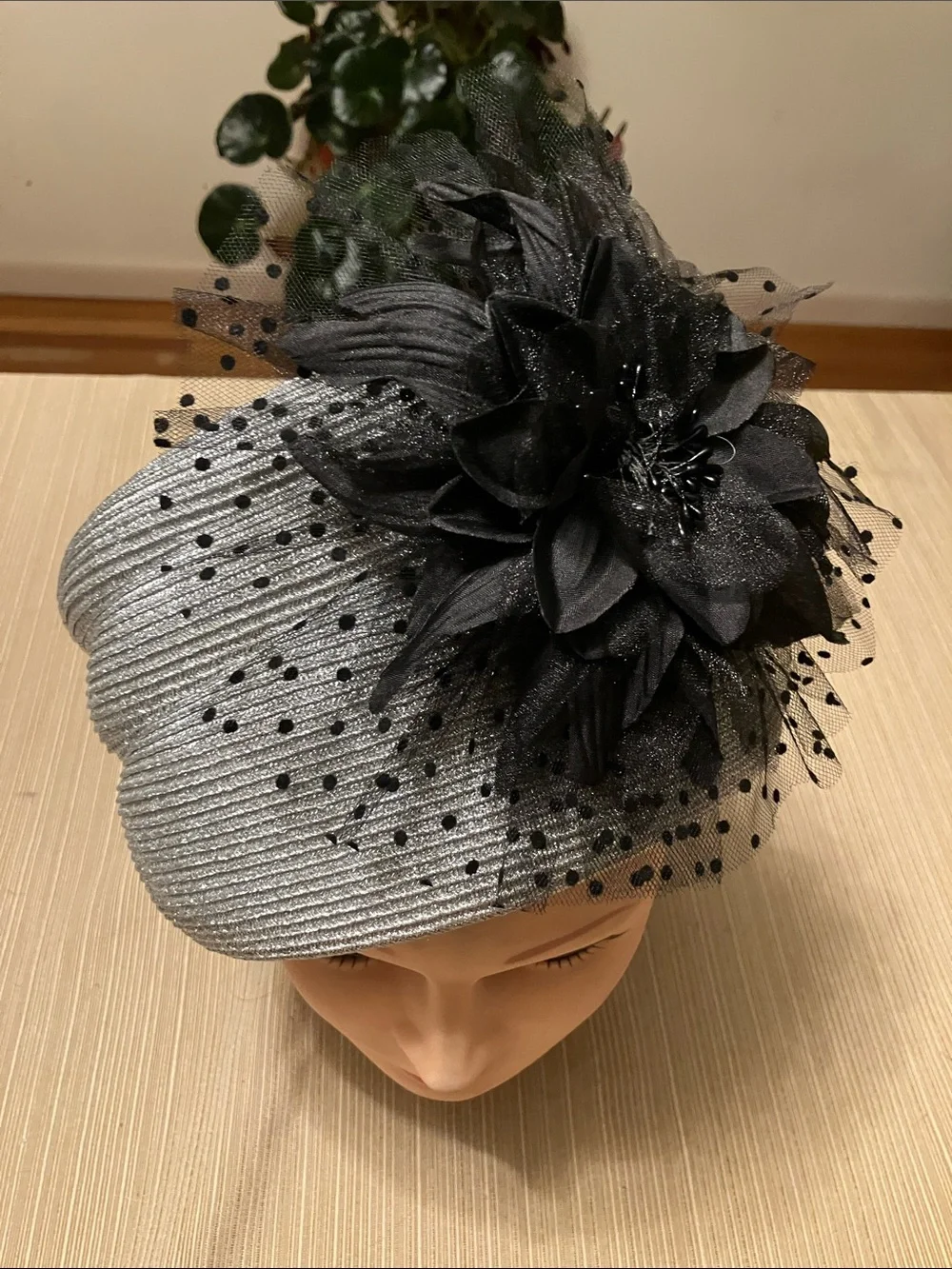 Elegant Metallic Silver Hat with Black Floral Accent